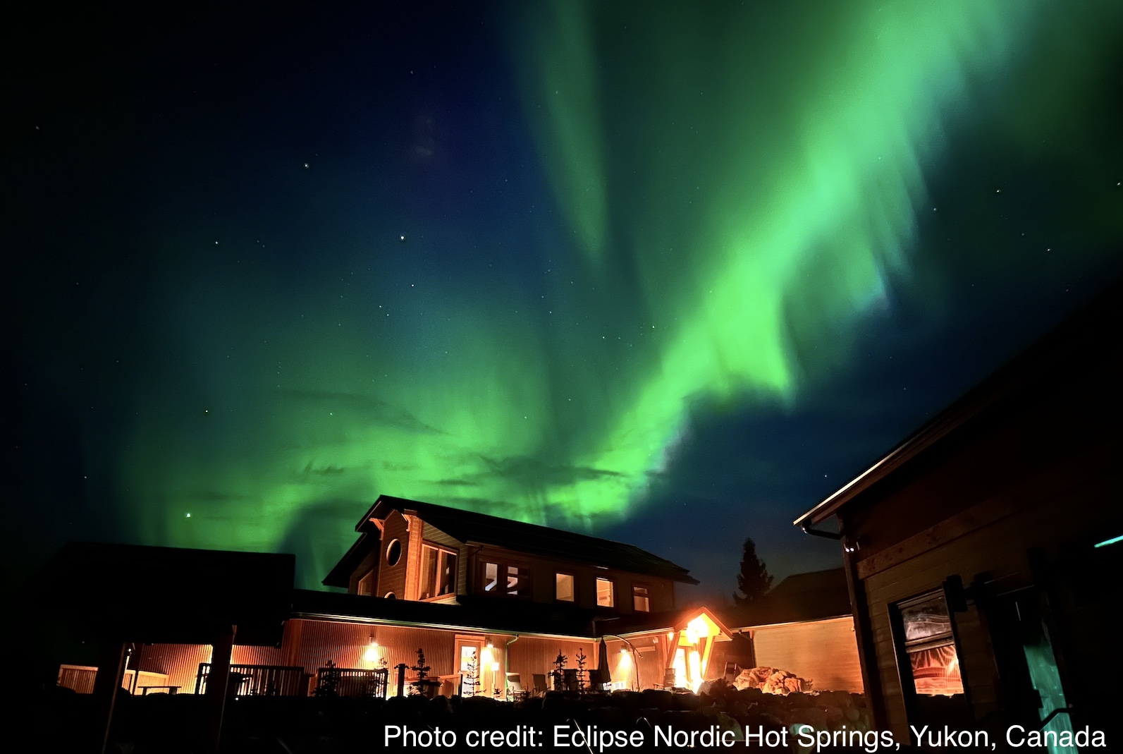 Photo of northern lights above the hot springs